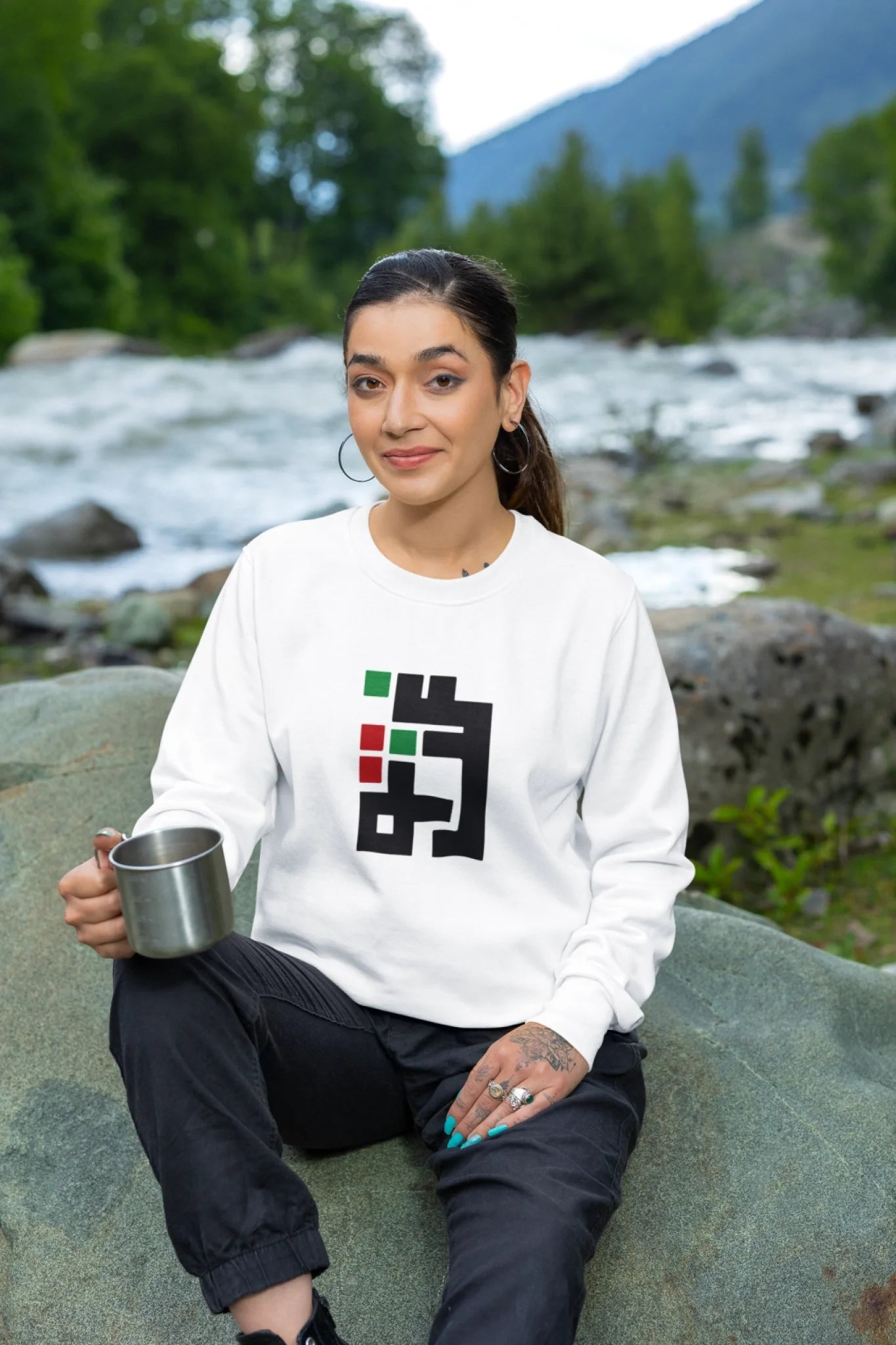 crewneck-sweatshirt-mockup-featuring-a-tattooed-woman-sitting-on-a-rock-m35583