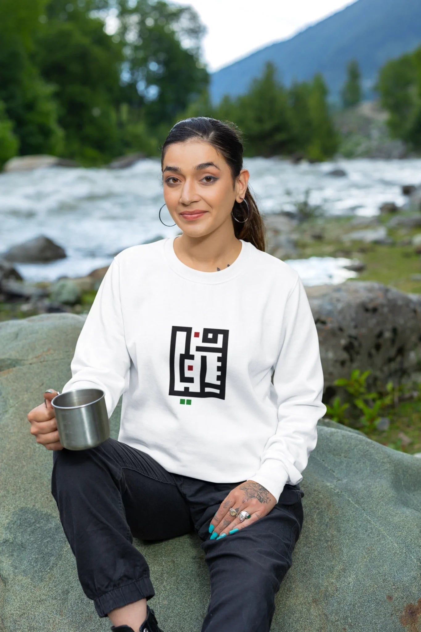 crewneck-sweatshirt-mockup-featuring-a-tattooed-woman-sitting-on-a-rock-m35583